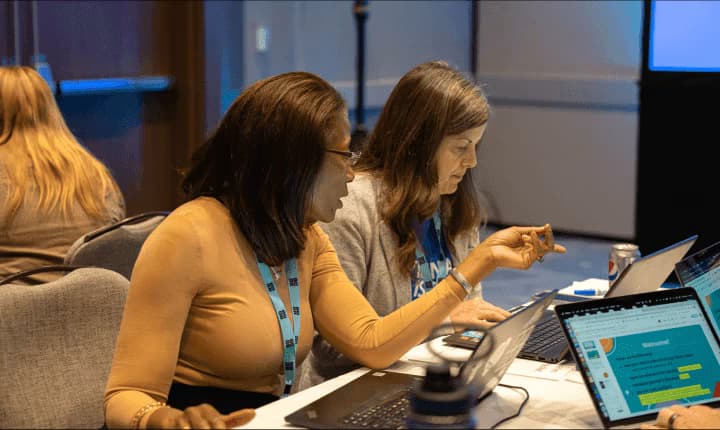 Teachers sitting and discussing at a Code.org event